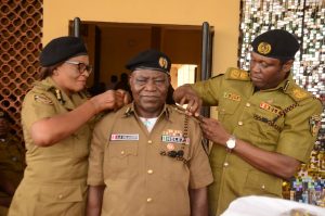 NDLEA EDO State Commander Mitchell Ofoyeju PhD decorating Adeola Salaudeen with the new rank of Commander of Narcotics together with newly promoted Commander of Narcotics Hope Aigbogun at the ceremony